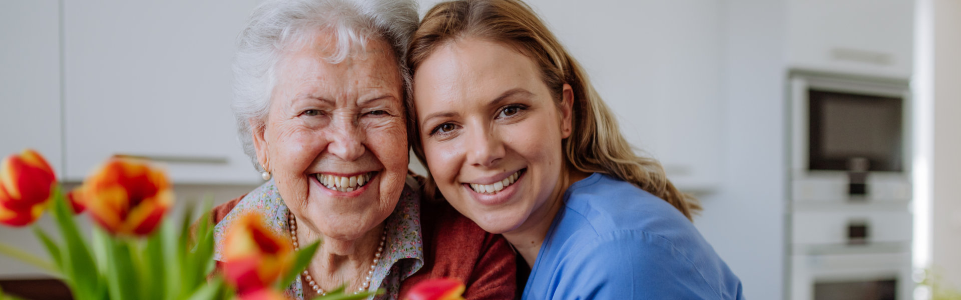 caregiver and senior woman smiling